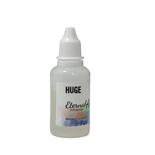 Load image into Gallery viewer, Small bottle labeled 'HUGE Eternal' on a white surface with a blurred background